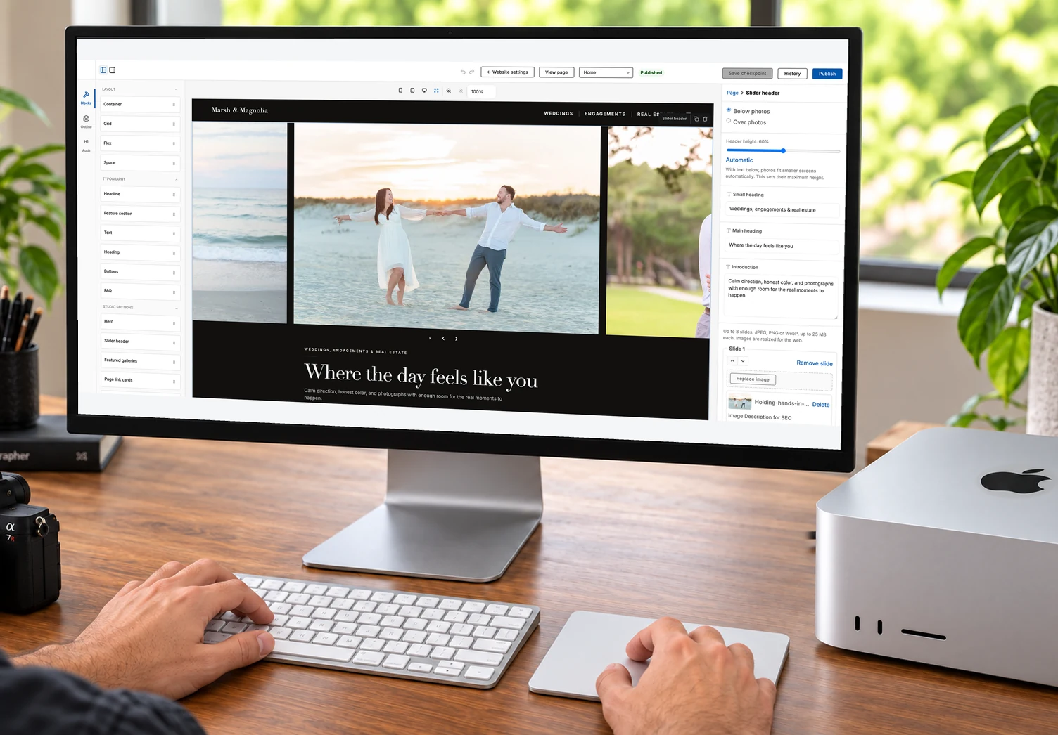 Photographer using the ShootCal Website Builder at a desk, with the real page editor displayed on the monitor